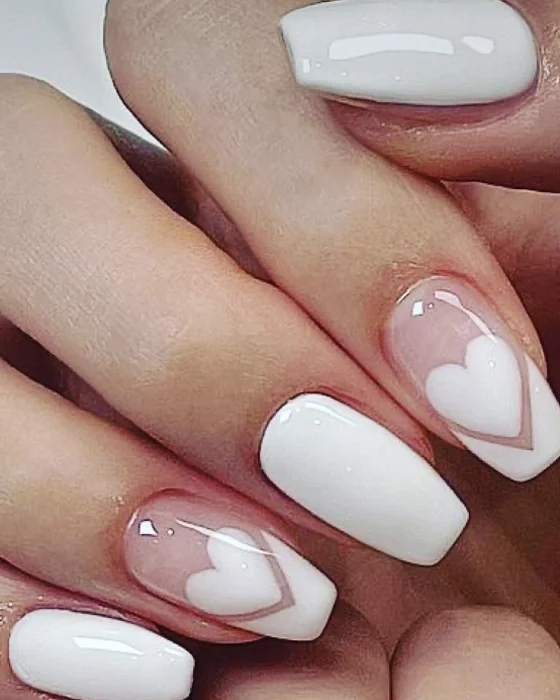 Ongles blancs carrés avec un coeur en contour sur l'annulaire
